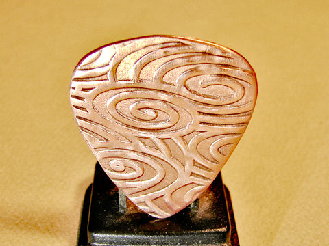 Copper guitar pick for swirling waves of sound