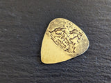 Brass guitar pick with horses , mountains and a hammered texture - playable