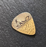 Desert quail bronze guitar pick with hammered texture