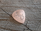 copper guitar pick with lizard