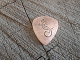 copper guitar pick with lizard