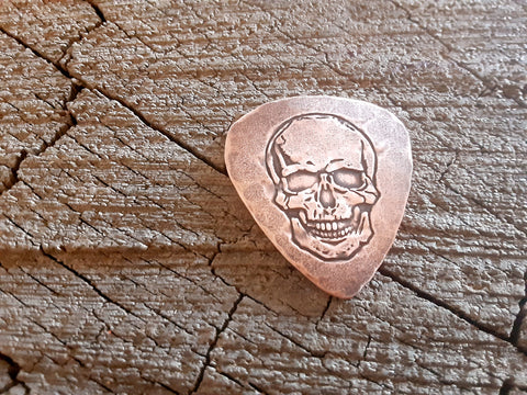handmade copper guitar pick with skull - playable