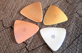 mixed bag of 4 triangular guitar picks in 4 different metals - playable
