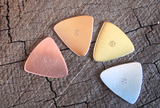 mixed bag of 4 triangular guitar picks in 4 different metals - playable