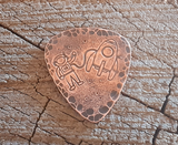 copper guitar pick with astronaut
