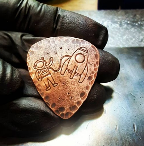 copper guitar pick with Astronaut and Rocket