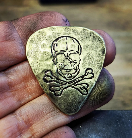 brass guitar pick - playable with skull and cross bones