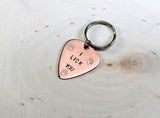 Dog tag in guitar pick shape made from copper
