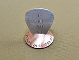 Copper guitar pick stand rocking with music is love in search of a word