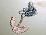 Winged copper guitar necklace with musical inspiration