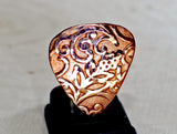 Rococo copper guitar pick with asymmetrical vine design