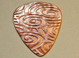 Copper guitar pick for swirling waves of sound