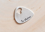 Je t'aime aluminum guitar pick with heart cut out and stamped in the language of love