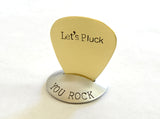 Brass guitar pick with Let’s Pluck