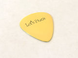 Brass guitar pick with Let’s Pluck