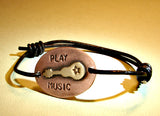 Leather bracelet with bronze guitar on copper play music edition
