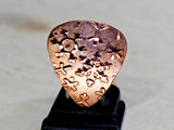 Copper snowflake guitar pick for wintertime tunes