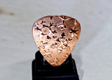 Copper snowflake guitar pick for wintertime tunes