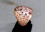 Copper snowflake guitar pick for wintertime tunes