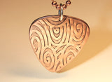Copper guitar pick necklace with swirling waves of sound