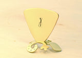 Triangular bronze bass guitar pick with musical inspiration