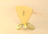 Triangular bronze bass guitar pick with musical inspiration