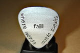 Stamped aluminum guitar pick where words fail music speaks
